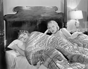 Displeasure: Two women together in bed under a blanket