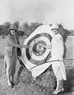 50 60: Women with bulls eye in archery target