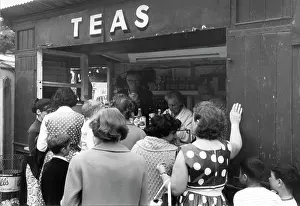 Prominently: Women and children queueing for refreshments at a kiosk