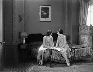 Grandiose: Two women confiding secrets in the bedroom