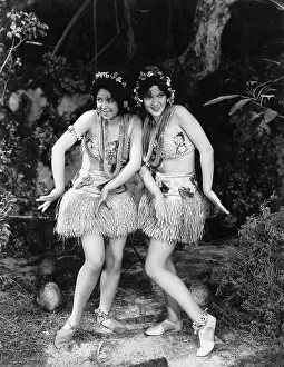 Conformity: Two women dancing in grass skirts