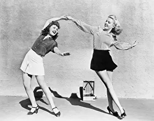 Collaborate: Two women dancing outside