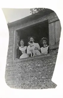 Pebble: Three women with a dog at an open window