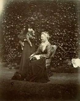 Wickerwork: Two women with two dogs in a garden