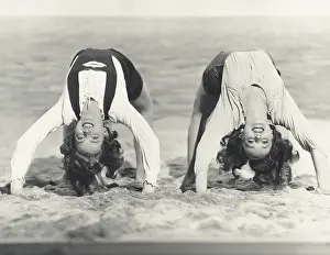 Steadiness: Two women doing backbends on the beach