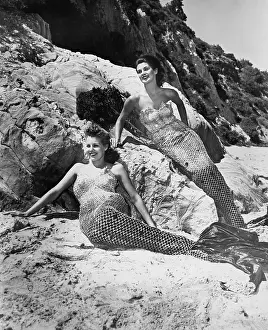 Fictitious: Women dressed as mermaids on the beach