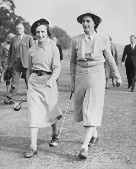 Strolling: Two women golfers on a golf course