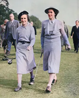 Strolling: Two women golfers on a golf course