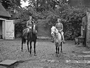 Dapple: Two women on horseback in stable yard