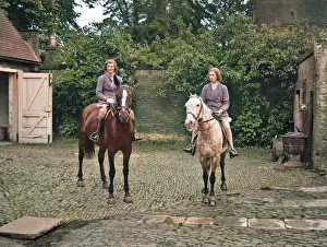 Dapple: Two women on horseback in stable yard