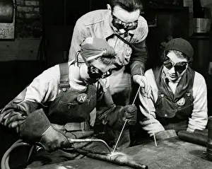 Welding: Two women learning to weld with their instructor, 1943