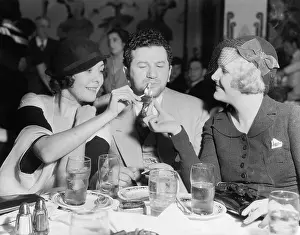 Affections: Two women lighting a cigarette for a man