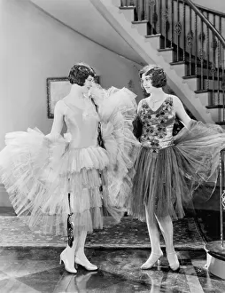 Celebratory: Two women looking at each others dresses