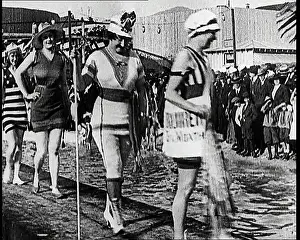 Women Parading Along A Pier In Bathing Suits