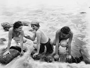 Vigorous: Three women playing in water on the beach