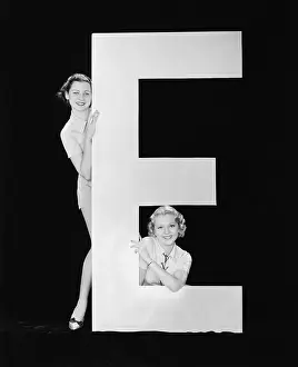 Vowels: Women posing with huge letter E
