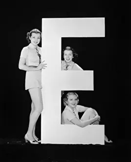 Vowels: Women posing with huge letter E