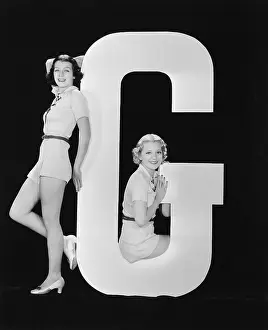 Testimonial: Women posing with huge letter G