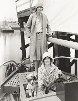 Obedient: Two women out sailing with their mascot