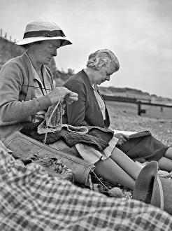 Pebbly: Two women sitting on a beach