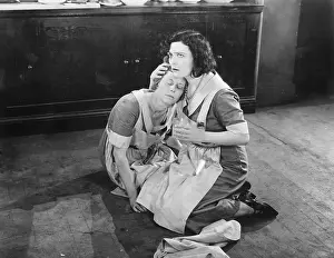 Exhausting: Two women sitting on the floor while one is holding