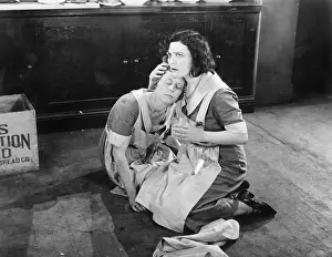 Exhausting: Two women sitting on the floor while one is holding