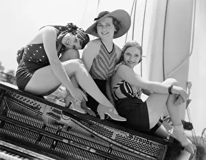 Time Off: Three women sitting on top of a piano