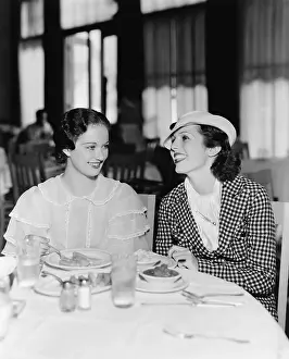 Foodstuff: Two women sitting together in a restaurant