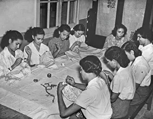 Tablecloths: Women sitting at a table sewing