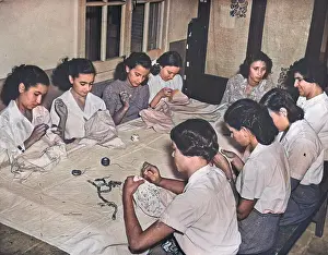 Tablecloths: Women sitting at a table sewing