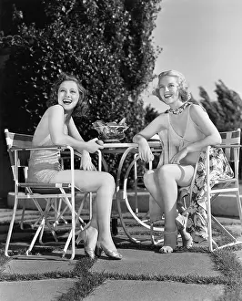 Pleasurable: Two women sitting together in a back yard