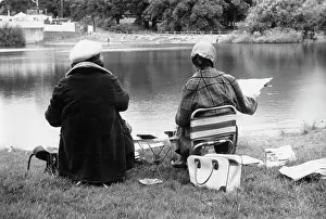 Clipped: Two women sketching by a pond