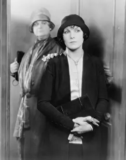 Daydreaming: Two women standing together at a door