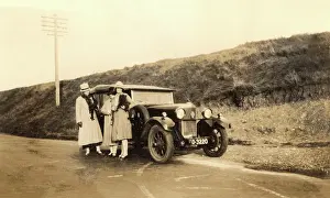 Numberplate: Women standing by large car