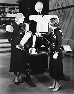 Merchandising: Two women in a store looking at the display