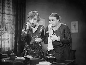 Tense: Two women with telephone