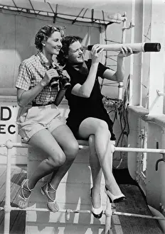 Binocular: Two women with a telescope and a binocular