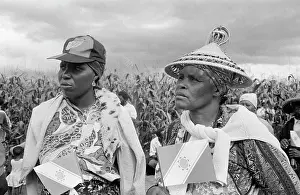 Lesotho: Two women walking through the maize / corn / mealies