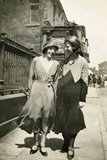 Cloche: Two women walking together along a street