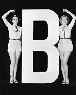 Sameness: Women waving with huge letter B