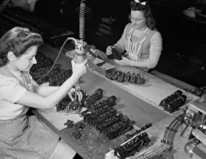 Haven: Women workers using an electric screwdriver