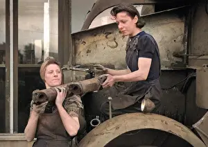 Piping: Two women working in a garage