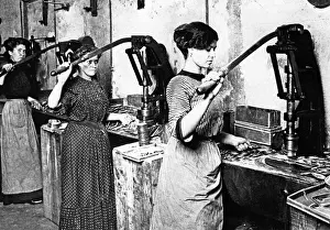 Canning: Women working at a punching machine, 1911