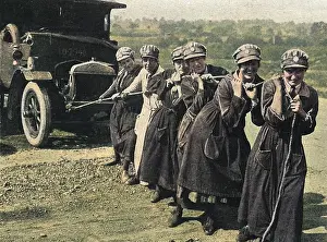 Women's Legion pulling a broken down ambulance, WWI
