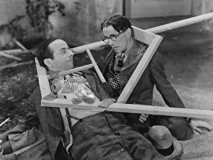 Destructive: Wooden frame broken over two mens heads
