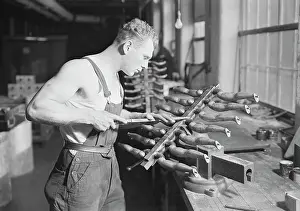 Chisel: Worker building rubber doll molds, 1936