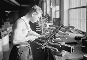Chisel: Worker building rubber doll molds, 1936