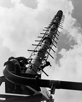 Consist: Worker climbing a Helical television antenna ?
