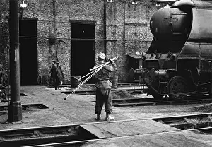 Bedford: Worker with fire-irons at Nine Elms Old Shed