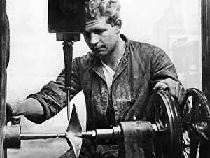Machining: Worker at a lathe, 1931